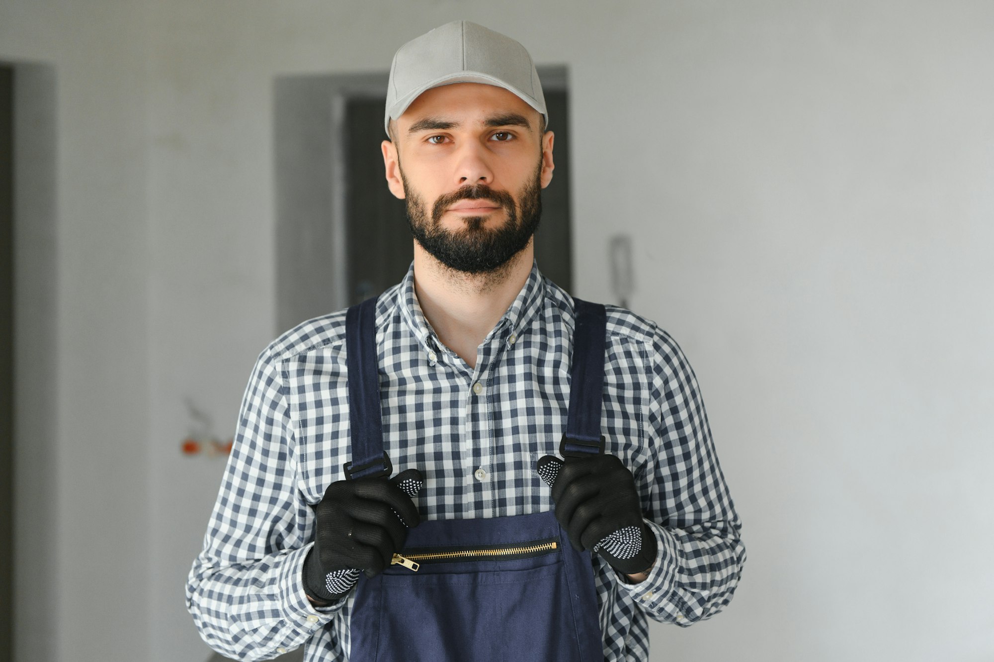 Builder handyman with construction tools. House renovation background.