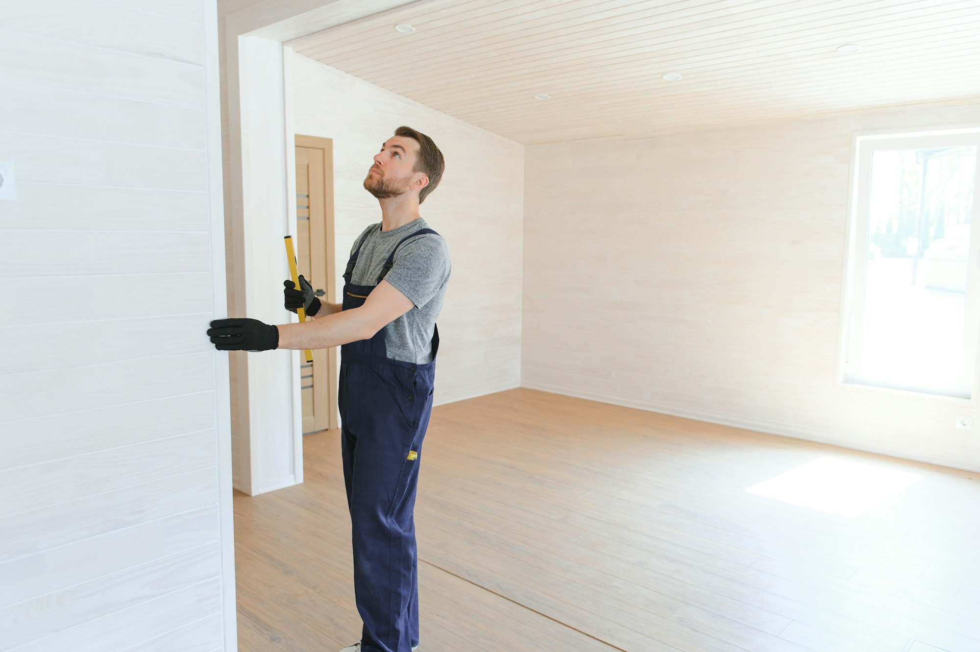 Construction worker in new house. Renovation background.