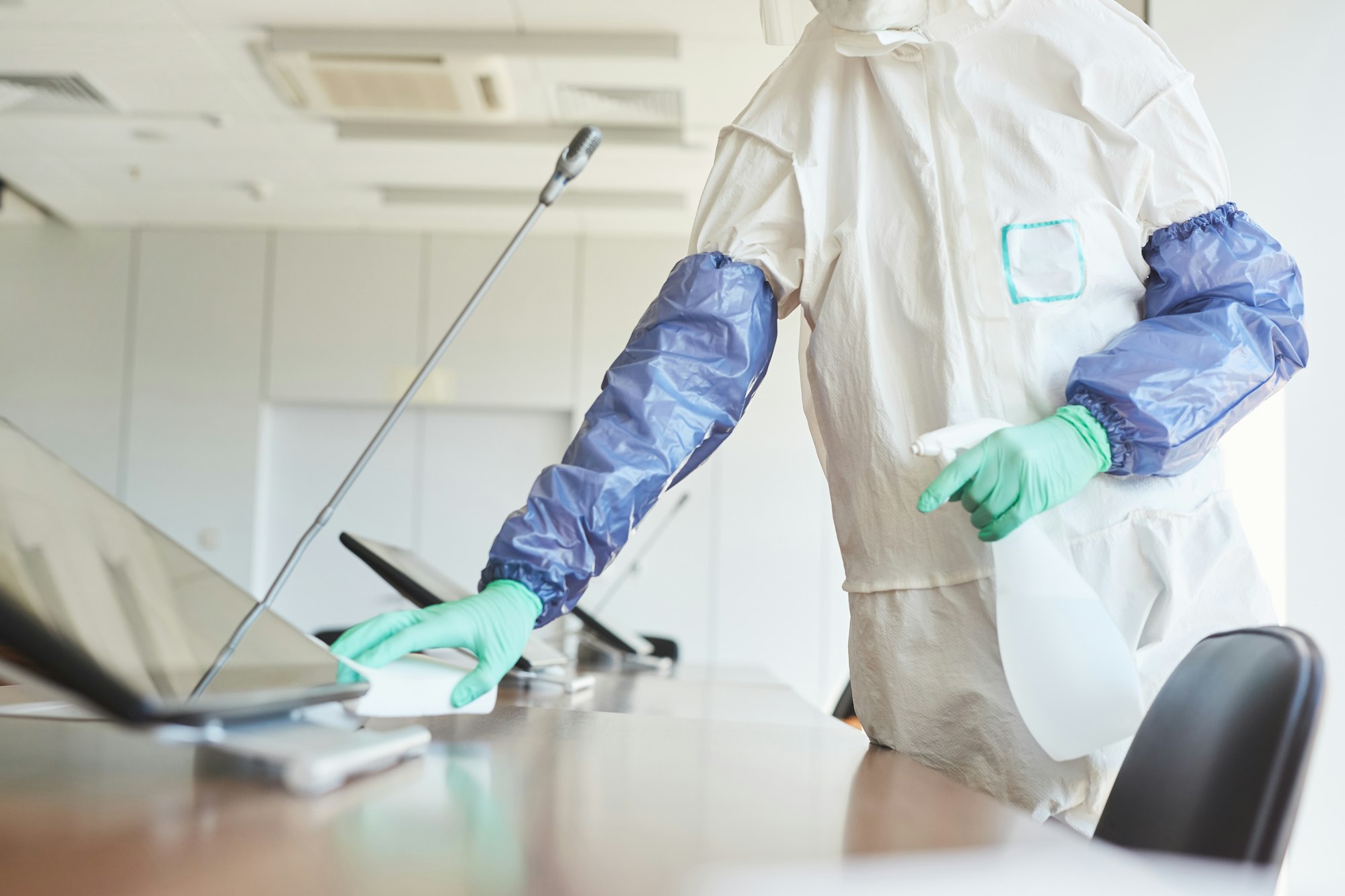 Worker Cleaning Office Table Close Up